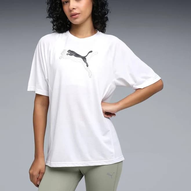 Women's oversized white graphic T-shirt featuring a stylish Puma logo print. Made from soft, breathable fabric with a relaxed fit for ultimate comfort and effortless everyday style.